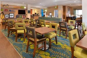 a dining room with tables and chairs in a restaurant at Hampton Inn Portland East in Portland