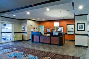 a lobby with a reception desk in a hotel at Hampton Inn & Suites Denison in Denison