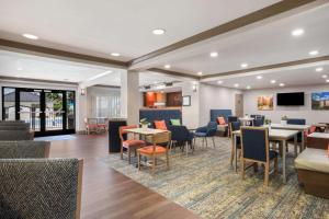 a lobby with tables and chairs and a waiting room at Hampton Inn Princeton in Princeton