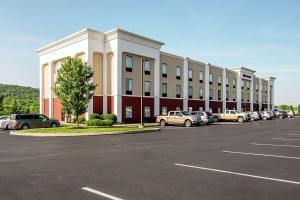 a large building with cars parked in a parking lot at Hampton Inn Pine Grove in Pine Grove
