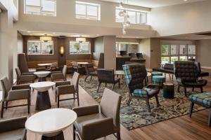 a waiting room at a hospital with chairs and tables at Residence Inn by Marriott Detroit Farmington Hills in Farmington Hills