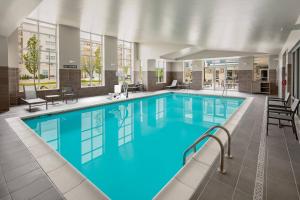 a large pool with blue water in a building at Residence Inn by Marriott Detroit Farmington Hills in Farmington Hills