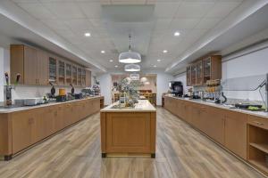 a large kitchen with wooden cabinets and a large island at Hampton Inn Chula Vista Eastlake in Chula Vista