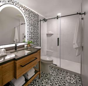 a bathroom with a sink and a toilet and a shower at Hotel Virginia Santa Barbara, Tapestry Collection by Hilton in Santa Barbara