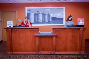 two women are standing behind the bar at Hampton Inn Sidney in Sidney