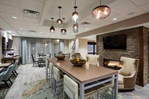 a lobby with a fireplace and a living room at Hampton Inn Spicer Green Lake, MN in Spicer