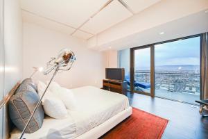 a bedroom with a bed and a large window at Intimo Palms Place Penthouse in Las Vegas