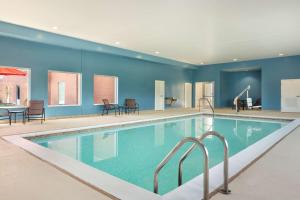 a pool in a hotel room with blue walls at Hampton Inn St. Louis-Columbia in Millstadt Junction