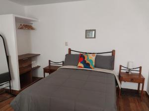 a bedroom with a large bed and a tv at Spondylus in Huanchaco
