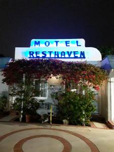 a hotel with a sign on the side of a building at Rest Haven Motel in Los Angeles