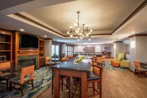 a large living room with a table and chairs at Hampton Inn Waldorf in Waldorf