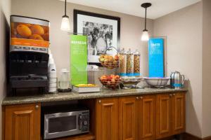 una encimera de cocina con microondas y fruta. en Hampton Inn & Suites Williamsburg-Central en Williamsburg