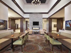 a lobby with tables and chairs and a fireplace at Homewood Suites by Hilton Halifax - Downtown in Halifax