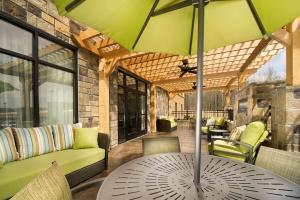 a patio with a table with a green umbrella at Hampton Inn Cleveland Tennessee in Cleveland