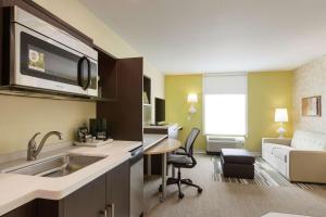 a kitchen with a sink and a living room at Home2 Suites by Hilton Canton in North Canton