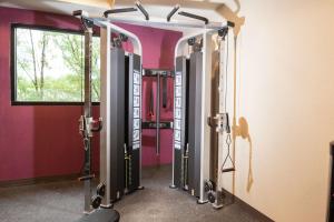 a gym with a row of tread machines in a room at Home2 Suites By Hilton King Of Prussia Valley Forge in King of Prussia