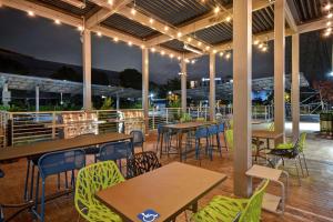 a patio with tables and chairs and lights at Home2 Suites By Hilton San Francisco Airport North in South San Francisco