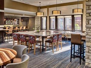 a dining room with a large table and chairs at Hilton Garden Inn Gatlinburg in Gatlinburg