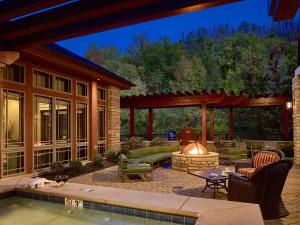 an outdoor patio with a fireplace and a fire pit at Hilton Garden Inn Gatlinburg in Gatlinburg
