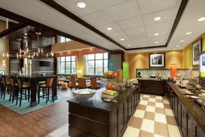 a large kitchen and dining room with a restaurant at Hampton Inn and Suites Houston Pasadena in Pasadena