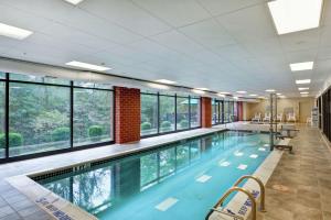 a large swimming pool with windows in a building at Hampton Inn Tunkhannock in Tunkhannock