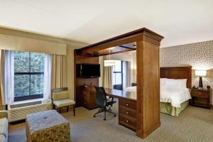 a hotel room with a bed and a desk and a bedroom at Hampton Inn Tunkhannock in Tunkhannock