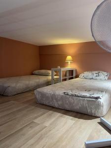 a room with two beds and a table with a lamp at Modern House in Mytilene Center in Mytilini