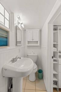 a white bathroom with a sink and a toilet at Walk 2 beach A C W D Work Desk Renovated in Hermosa Beach