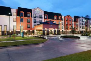 a large apartment building with a parking lot at Homewood Suites by Hilton Slidell in Slidell