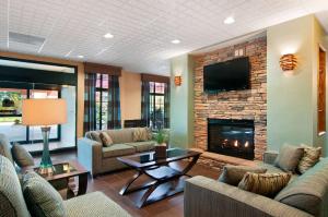 a living room with couches and a fireplace at Homewood Suites by Hilton Slidell in Slidell