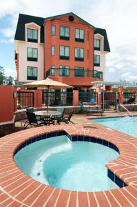 a swimming pool with a building in the background at Homewood Suites by Hilton Slidell in Slidell