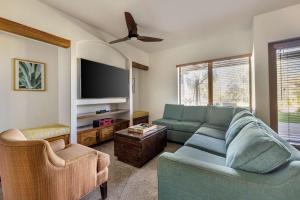 a living room with a couch and a flat screen tv at Hilton Grand Vacations Club Palm Desert in Palm Desert