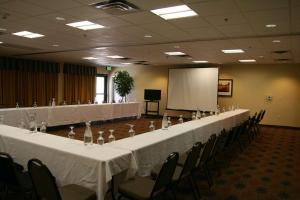 a long table with white tables and chairs in a room at Hampton Inn and Suites Pueblo/North in Pueblo