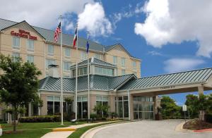 un hotel con dos banderas americanas encima en Hilton Garden Inn Austin NorthWest/Arboretum, en Austin