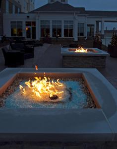a fire pit with flames in the middle of a courtyard at Hilton Garden Inn Cedar Falls Conference Center in Cedar Falls