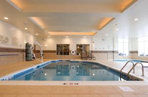 a large swimming pool in a building with a pool at Hilton Garden Inn Cedar Falls Conference Center in Cedar Falls