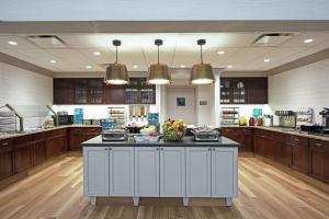 a large kitchen with a large island in the middle at Homewood Suites by Hilton Albany in Albany
