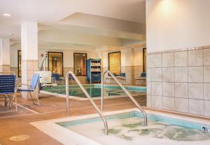 a swimming pool in a hotel lobby with a pool at Hampton Inn & Suites Lathrop in Lathrop