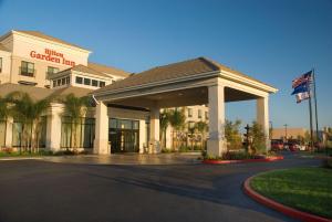 a hotel with a gated entrance to a building at Hilton Garden Inn Sacramento Elk Grove in Elk Grove