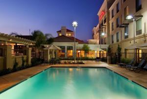 a swimming pool in front of a hotel at night at Hilton Garden Inn Sacramento Elk Grove in Elk Grove
