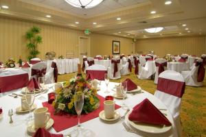 a banquet hall with white tables and red chairs at Hilton Garden Inn Sacramento Elk Grove in Elk Grove +33 photos