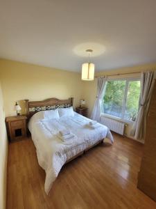 a bedroom with a large bed and a window at Casa Lago Argentino in El Calafate