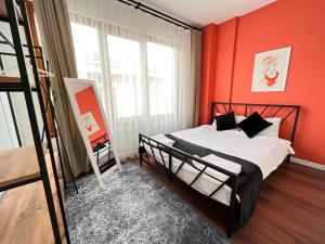 um quarto com paredes cor de laranja e uma cama num quarto em The Pillo Mansion em Istambul