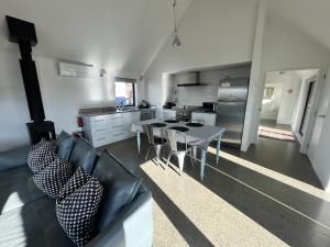 a living room with a table and a kitchen at Mary Hut in Lake Tekapo