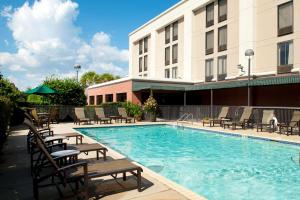 a swimming pool in front of a hotel at Hampton Inn Pensacola-Airport in Pensacola