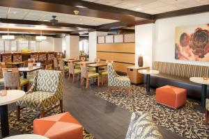 a restaurant with tables and chairs and a bar at Hampton Inn Pensacola-Airport in Pensacola