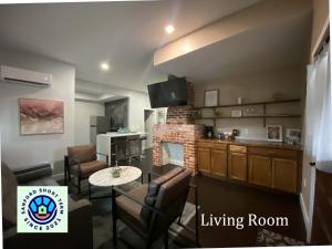 a living room with a table and chairs and a kitchen at The Front Porch in Sanford