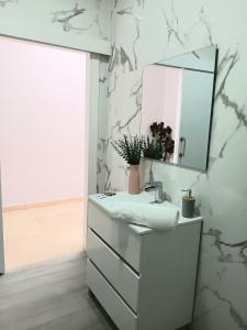 a bathroom with a sink and a mirror at Apartamentos Tierra Bobal in Requena