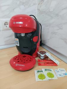 a red blender sitting on top of a table at Apartamentos Tierra Bobal in Requena