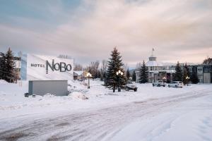 a snowy street with a hotel novo sign in the snow at Hotel NoBo Cascade, Tapestry Collection by Hilton in Cascade